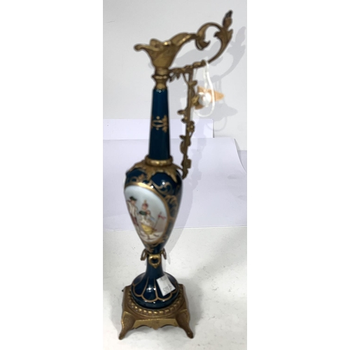 509B - A 19th century French gilt metal and porcelain ewer with panel depicting couple, height 19cm