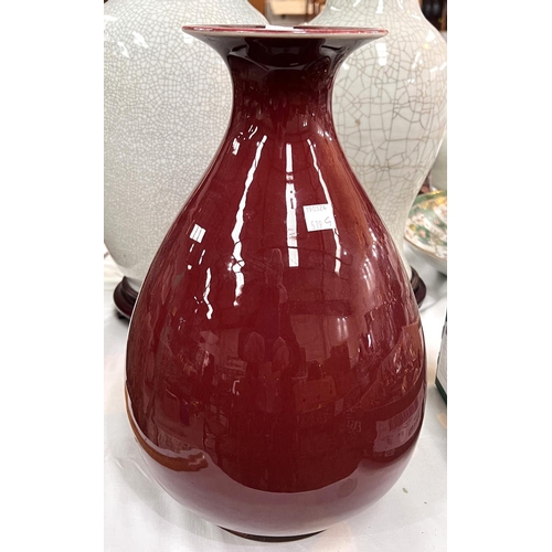 519G - A Chinese Oxblood glazed vase with bulbous body, flared rim, associated stand, ht. 35cm incised mark... 