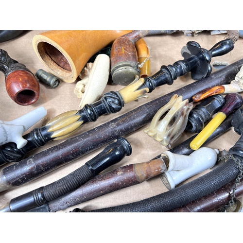 555A - A collection of ceramic and other pipe parts, novelty revolver etc, German etc