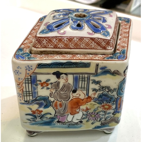 509C - A Chinese lidded pot with polychrome domestic scenes, diamond shape with pierced lid, length 10.5cm