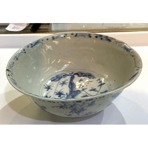 515A - A Chinese possibly ming period blue and white bowl with plants and flowers, (rim restored)