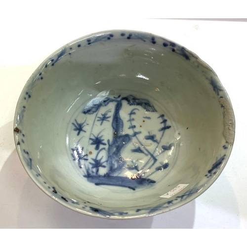 515A - A Chinese possibly ming period blue and white bowl with plants and flowers, (rim restored)