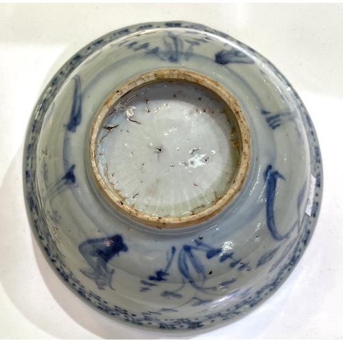 515A - A Chinese possibly ming period blue and white bowl with plants and flowers, (rim restored)