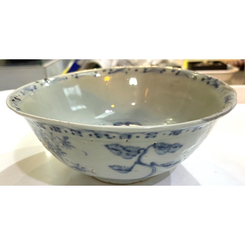 515A - A Chinese possibly ming period blue and white bowl with plants and flowers, (rim restored)