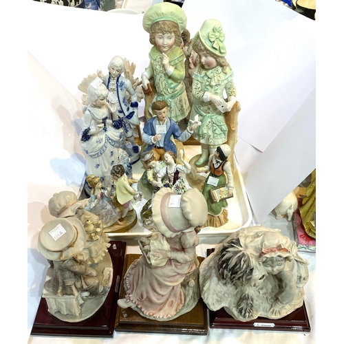 573A - A selection of Capodimonte Armani figures of children and animals: five resin groups and a selection... 