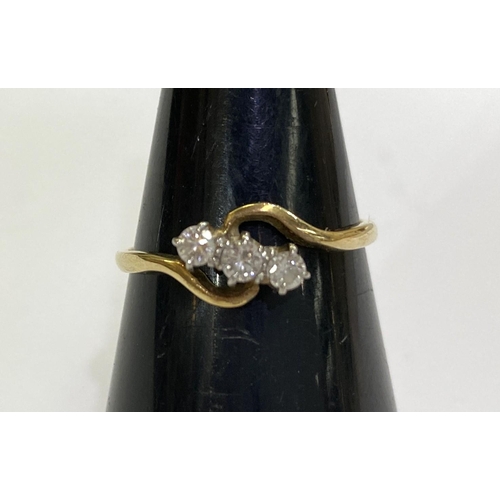 727 - A 3 stone diamond lady's dress ring in crossover style setting, the shank stamped 18ct PLAT, 2.4gm, ... 