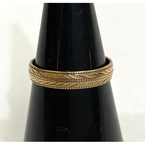 764 - A 9 carat hallmarked gold wedding ring with chased chevron decoration, size 'N', 1.5gms.