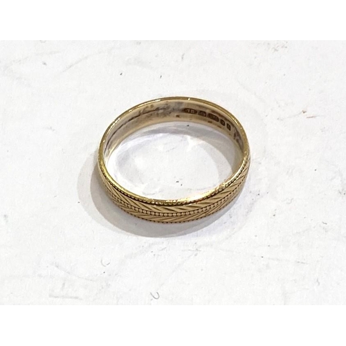 764 - A 9 carat hallmarked gold wedding ring with chased chevron decoration, size 'N', 1.5gms.