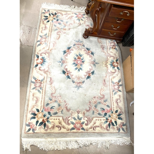 950 - A Chinese rug with floral pattern on a light blue groundNo bids sold with next lot