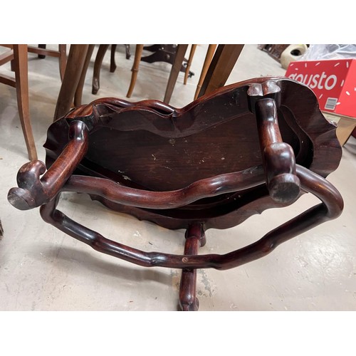 501A - A 19th century Chinese hardwood stand with lotus leaf frieze, carried on 3 legs united by a shaped s... 