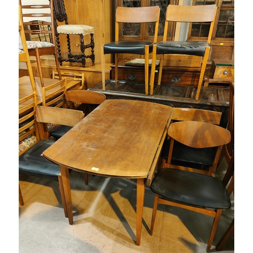 932 - A mid 20th century teak dining table, circular form with drop leaves and a set of 6 matched teak din... 