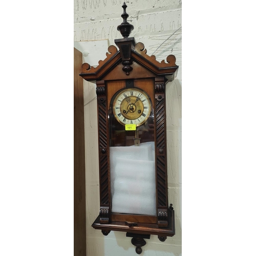 39 - A 19th century small walnut cased wall clock in the Vienna style, with spring driven movement