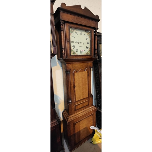 942 - An early 19th century oak and mahogany longcase clock with architectural pediment and turned columns... 