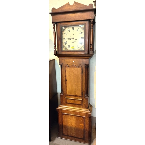 942 - An early 19th century oak and mahogany longcase clock with architectural pediment and turned columns... 