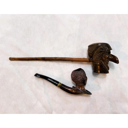 37 - A Meerschaum tobacco pipe with carved figural bowl; a Black Forest style carved wood pipe