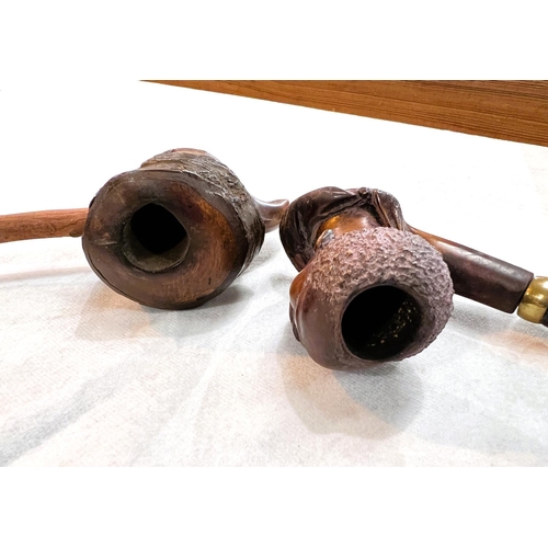 37 - A Meerschaum tobacco pipe with carved figural bowl; a Black Forest style carved wood pipe