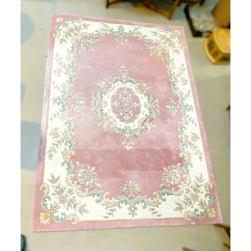 940 - An Indian rug with floral pattern against a pink ground, 285 x 200cm