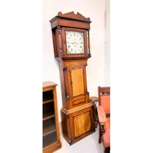 942 - An early 19th century oak and mahogany longcase clock with architectural pediment and turned columns... 