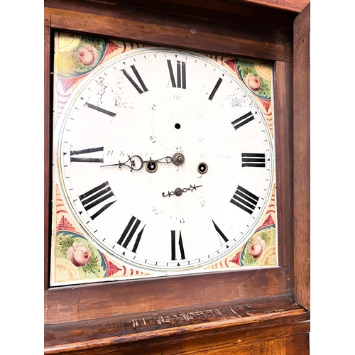 942 - An early 19th century oak and mahogany longcase clock with architectural pediment and turned columns... 