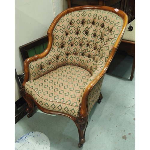 954 - A Victorian walnut framed deeply buttoned armchair with rounded back  