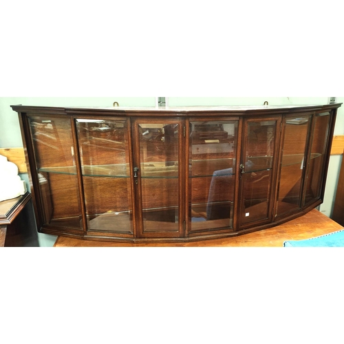 928 - An unusual wall mounted mahogany cabinet with bow front, enclosed by 2 doors with bevelled glass pan... 