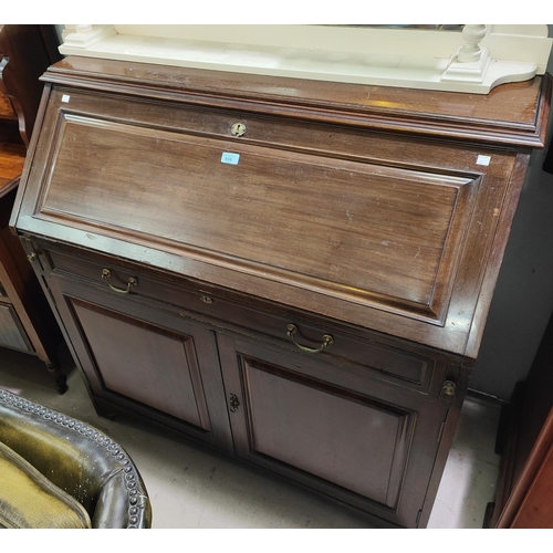 935 - A mahogany bureau with single drawers and double cupboards below, fall front interior, organised sec... 