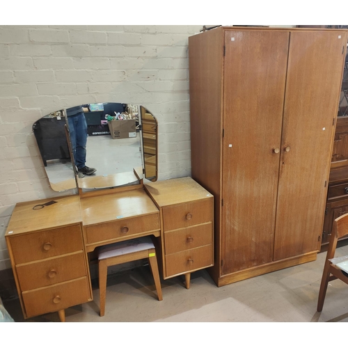 947 - A mid 20th century light oak dressing table and matching double wardrobe