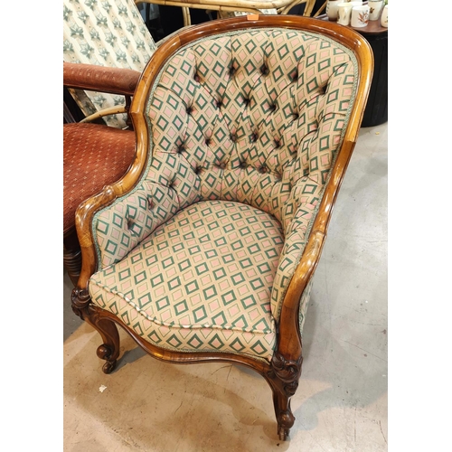 954 - A Victorian walnut framed deeply buttoned armchair with rounded back  