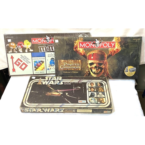 15 - Two board games with original seals:  Monopoly & Pirates of the Caribbean Monopoly; a Star Wars ... 