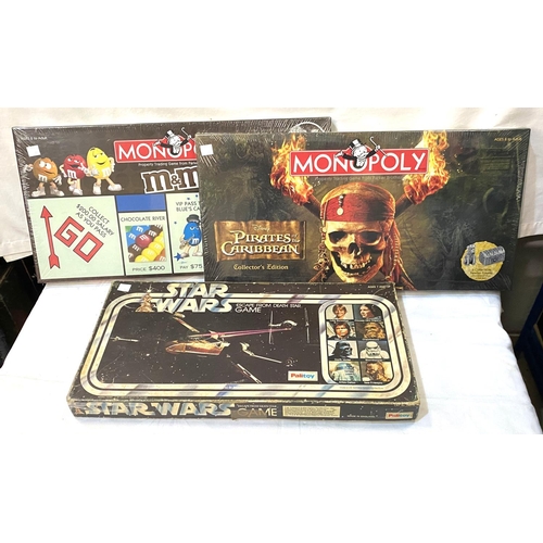 15 - Two board games with original seals:  Monopoly & Pirates of the Caribbean Monopoly; a Star Wars ... 