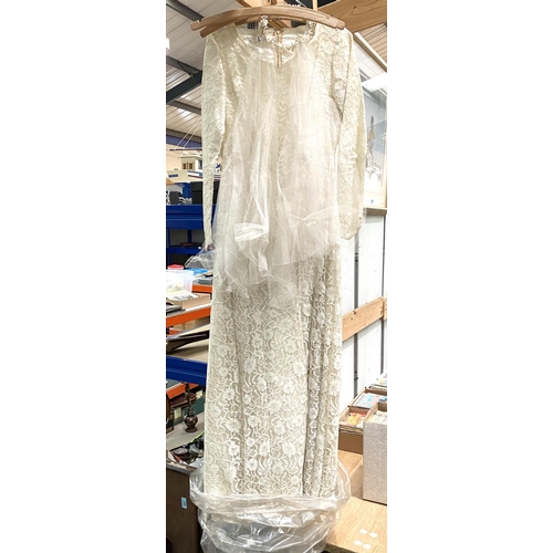 24 - A 20th century lace wedding dress with veil; a sewing box and contents