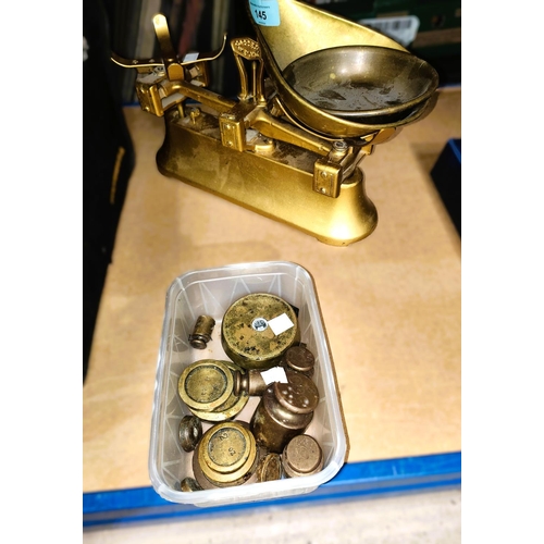 145 - A set of brass and cast metal kitchen scales and a selection of weights