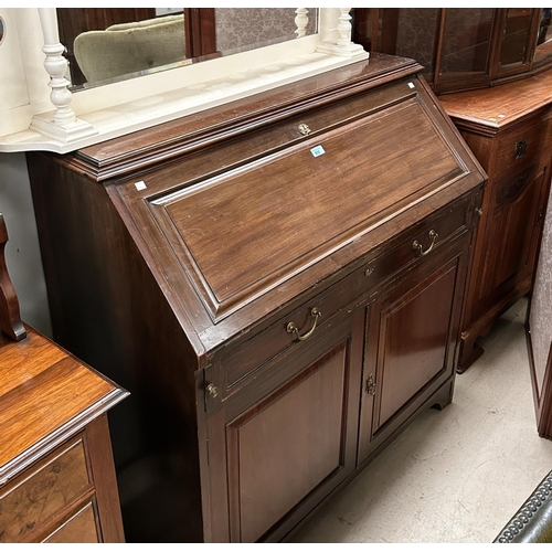 935 - A mahogany bureau with single drawers and double cupboards below, fall front interior, organised sec... 