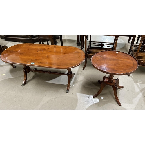 938 - A reproduction yew wood coffee table with rounded rectangular top and twin pedestals on splay feet; ... 