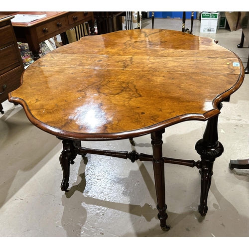 939 - A Victorian figured walnut Sutherland table with shaped oval top, on turned fluted supports and spla... 