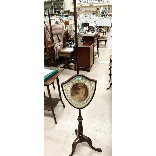 953 - A 19th century mahogany pole screen with shield shaped panel