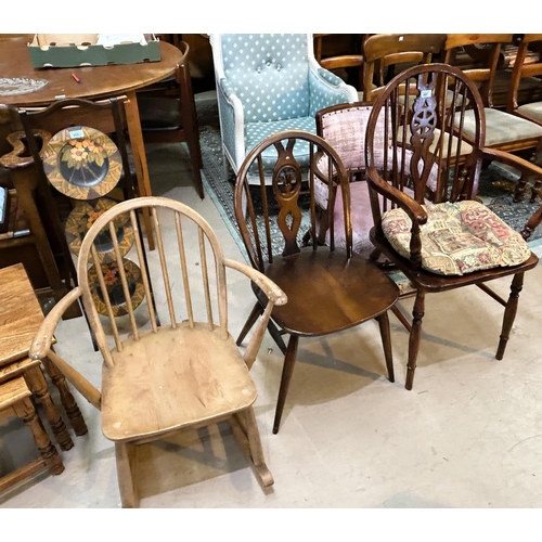 957 - A Windsor wheelback armchair; an Ercol dining chair; an Ercol lightwood stick back rocking chair