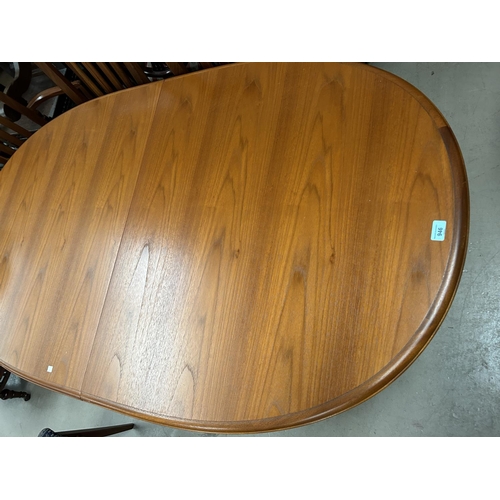 946 - A Staf light teak extending dining table with extra interior leaf and a set of 6 (4+2) chairs