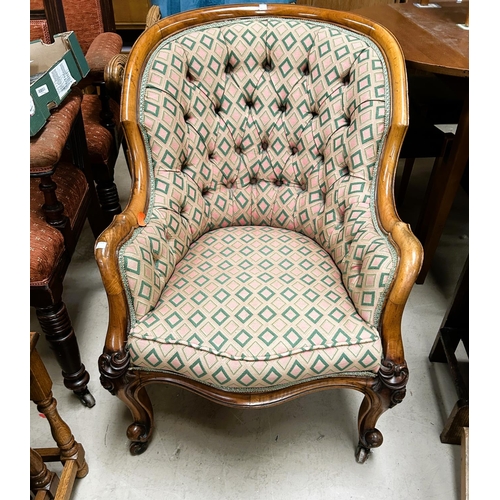 954 - A Victorian walnut framed deeply buttoned armchair with rounded back  