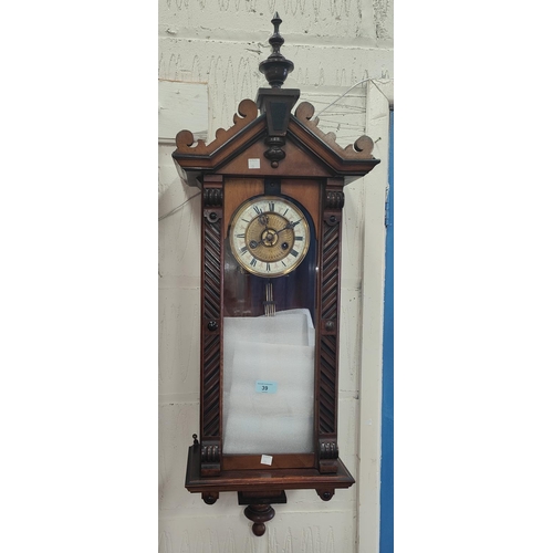 39 - A 19th century small walnut cased wall clock in the Vienna style, with spring driven movement