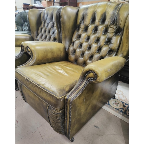 872 - A green leather effect Chesterfield style reclining armchair with deep button back with studded deco... 