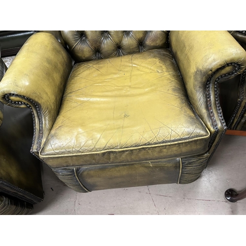 872 - A green leather effect Chesterfield style reclining armchair with deep button back with studded deco... 