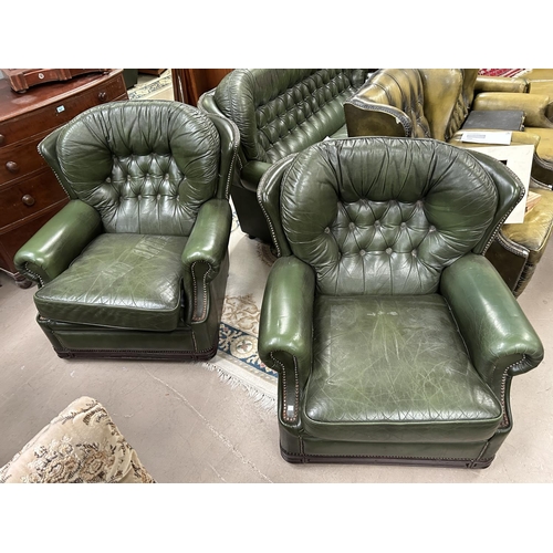 874 - A pair of green leather effect Chesterfield style armchairs and a matching 3 seater leather style se... 