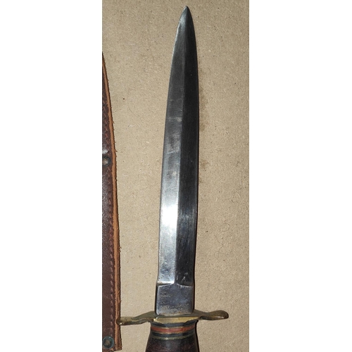 265 - An Early 20th century Fairbairn style fighting knife with horn handle and leather sheath