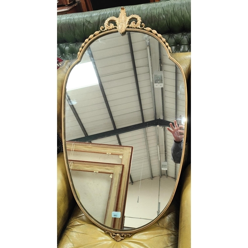 893 - An early 20th century gilt metal framed mirror in the Rococo style with beaded decoration to the rim... 