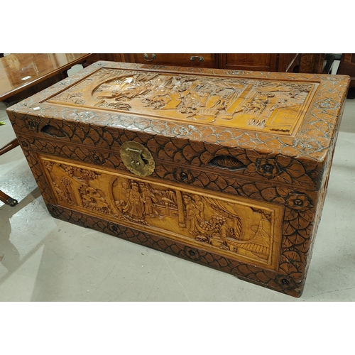 1000 - A good size heavily carved camphor wood chest with Asian scenes