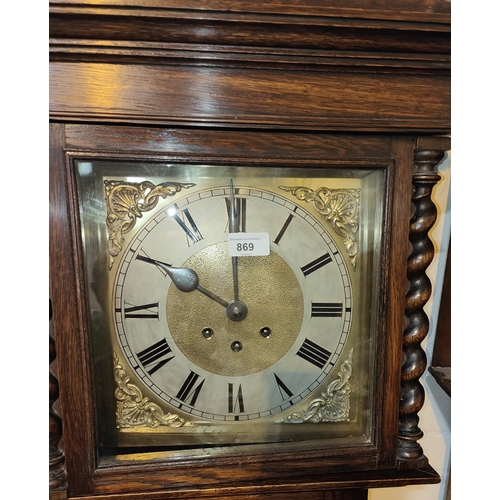 869 - An early 20th century oak longcase clock with barley twist columns to the hood, with square brass di... 