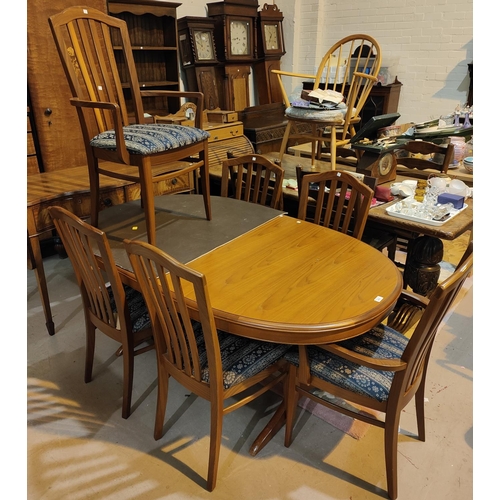 876 - A Staf light teak extending dining table with extra interior leaf and a set of 6 (4+2) chairs