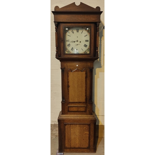 881 - An early 19th century oak and mahogany longcase clock with architectural pediment and turned columns... 