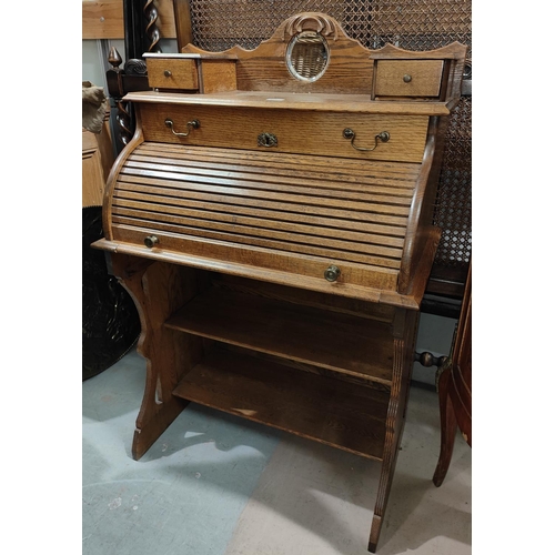 924 - An arts and crafts cylinder bureau with shelves below